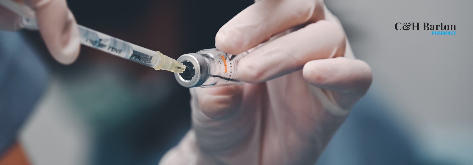 doctor pulling vaccine in syringe